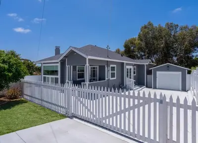 a white picket fence in front of a house at Fabulous New 4BR/3BA House in Mission Hills in San Diego