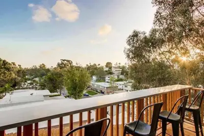 a balcony with chairs and a view of a city at Fabulous New 4BR/3BA House in Mission Hills in San Diego