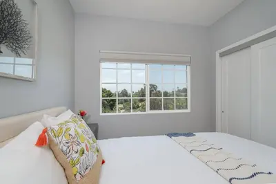 a white bedroom with a bed and a window at Fabulous New 4BR/3BA House in Mission Hills in San Diego