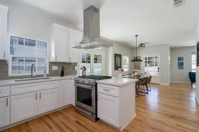 a kitchen with white cabinets and a stove top oven at Fabulous New 4BR/3BA House in Mission Hills in San Diego