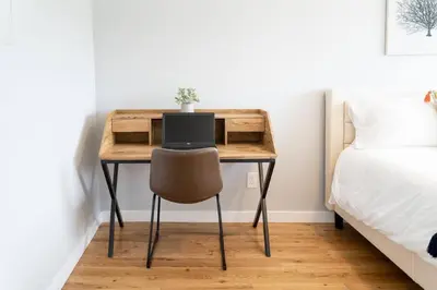 a desk with a laptop computer on it in a bedroom at Fabulous New 4BR/3BA House in Mission Hills in San Diego
