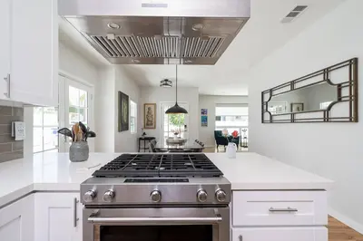a kitchen with a stove and white counter tops at Fabulous New 4BR/3BA House in Mission Hills in San Diego