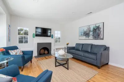 a living room with blue couches and a fireplace at Fabulous New 4BR/3BA House in Mission Hills in San Diego