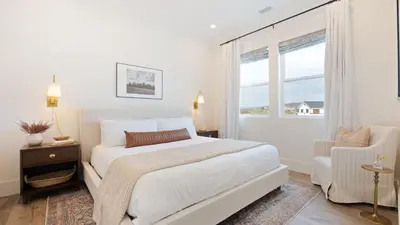 a white bedroom with a bed and a window at Pinot Point by AvantStay Massive Estate 10 mins from Temecula Wineries in Temecula