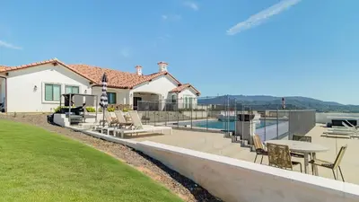 a house with a pool with chairs and a table at Pinot Point by AvantStay Massive Estate 10 mins from Temecula Wineries in Temecula