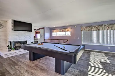 a room with a pool table and a fireplace at Escondido Hilltop Home with Deck and Views! in Escondido