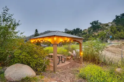 a gazebo with a bench in a garden with lights at Escondido Hilltop Home with Deck and Views! in Escondido