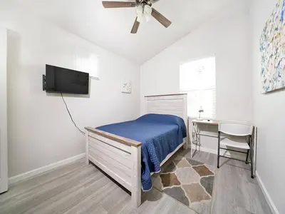 a bedroom with a bed and a desk and a television at King-30min to Airport-Self Check In-Parking-367Mbps in Rancho Santa Margarita