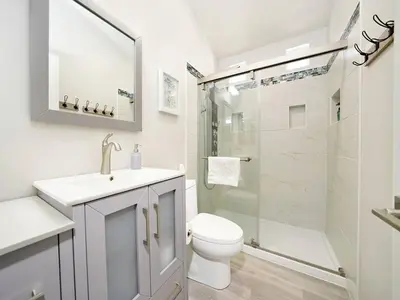 a white bathroom with a toilet and a shower at King-30min to Airport-Self Check In-Parking-367Mbps in Rancho Santa Margarita