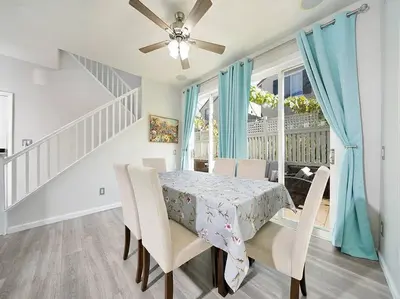 a dining room with a table and chairs and a ceiling fan at King-30min to Airport-Self Check In-Parking-367Mbps in Rancho Santa Margarita