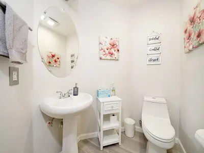 a bathroom with a sink and a toilet and a mirror at King-30min to Airport-Self Check In-Parking-367Mbps in Rancho Santa Margarita