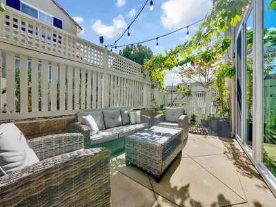 a patio with a couch and chairs on a balcony at King-30min to Airport-Self Check In-Parking-367Mbps in Rancho Santa Margarita
