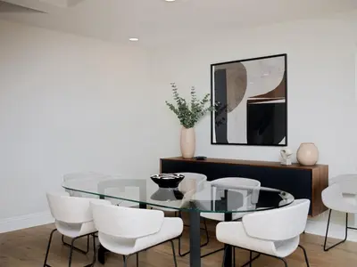 a dining room with a glass table and white chairs at Grandview Getaway, Luxury 4BR, Ocean View, Fire Pit in Encinitas