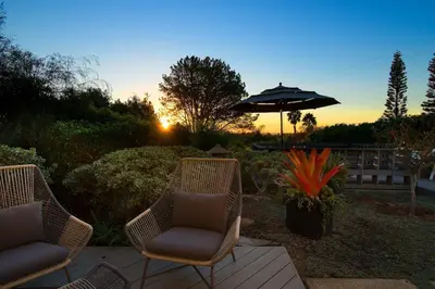 two chairs and an umbrella on a wooden patio at Grandview Getaway, Luxury 4BR, Ocean View, Fire Pit in Encinitas