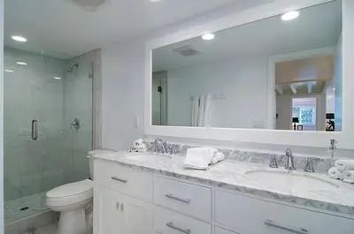 a bathroom with a sink and a toilet and a mirror at Remodeled Beach Bungalow, Block to the Beach in Carlsbad