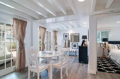 a dining room with a table and chairs and a bedroom at Remodeled Beach Bungalow, Block to the Beach in Carlsbad