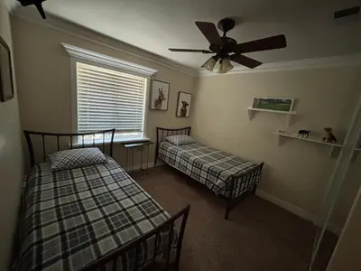 a bedroom with two beds and a ceiling fan at Peaceful & Cozy 3 bedroom Ranch-Home w/Fireplace in Hemet