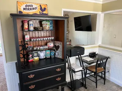 a black cabinet with a desk and a table and a table and a tablektop at Peaceful & Cozy 3 bedroom Ranch-Home w/Fireplace in Hemet