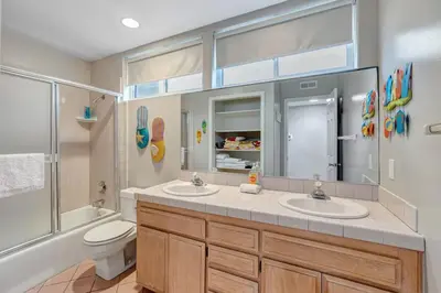 a bathroom with two sinks and a toilet at OCEAN FRONT - STUNNING VIEWS- VACATION PARADISE!! in Dana Point