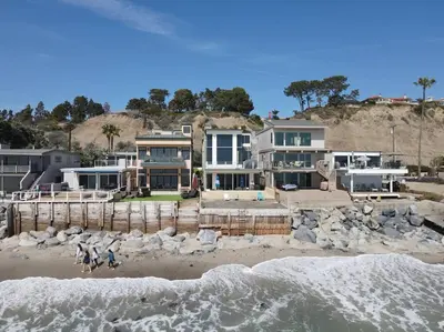 a house sitting on top of a beach next to the ocean at OCEAN FRONT - STUNNING VIEWS- VACATION PARADISE!! in Dana Point