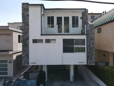 a white house with a window on the side of it at OCEAN FRONT - STUNNING VIEWS- VACATION PARADISE!! in Dana Point