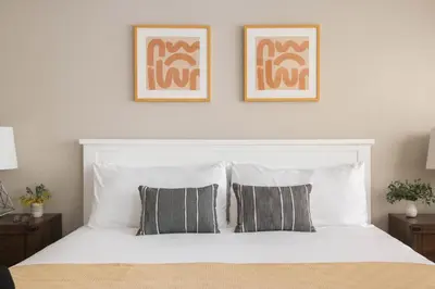 a bedroom with a white bed with two pillows at Seashore Suites by AvantStay in San Diego