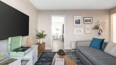 a living room with a couch and a tv at Seashore Suites by AvantStay in San Diego
