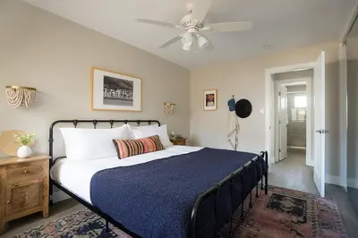 a bedroom with a bed and a ceiling fan at Seashore Suites by AvantStay in San Diego