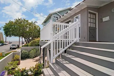 a house with a white porch and stairs at Walk to Beach, Patio with Ocean View, AC in Carlsbad