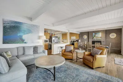 a living room with a couch and a table at ON THE SAND!! Private Beach! OCEAN FRONT HOT TUB!! in Dana Point