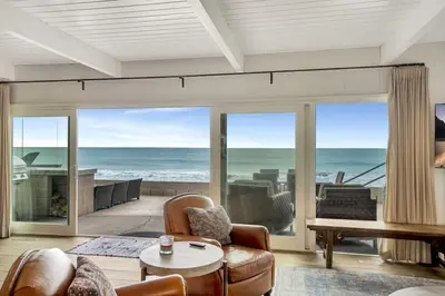 a living room with a view of the ocean at ON THE SAND!! Private Beach! OCEAN FRONT HOT TUB!! in Dana Point