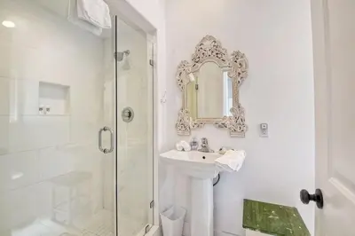 a white bathroom with a sink and a shower at Ocean Views, Across The Street From Beach, Private Patio in Carlsbad