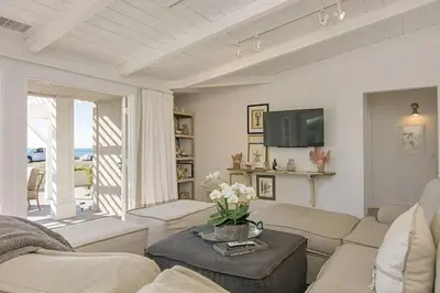 a living room with a couch and a table at Ocean Views, Across The Street From Beach, Private Patio in Carlsbad