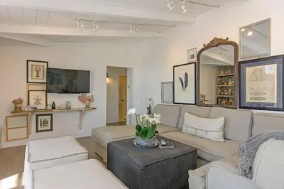a living room with white furniture and a mirror at Ocean Views, Across The Street From Beach, Private Patio in Carlsbad