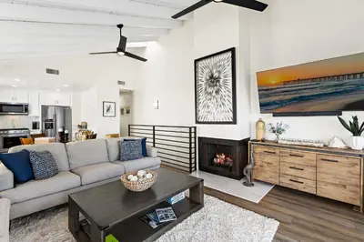 a living room with a couch and a fireplace at Amazing New & Water Vu/Balboa Peninsula! EV charge in Newport Beach