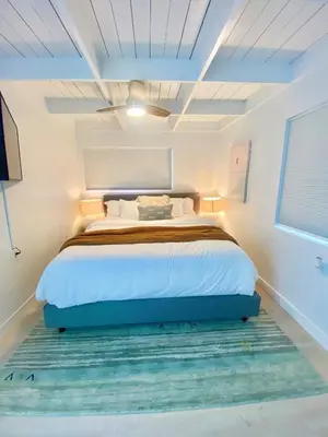 a bedroom with a bed with a blue bed frame at Village District! Cleo Beach! 5 Min Walk to DTWN! in Laguna Beach
