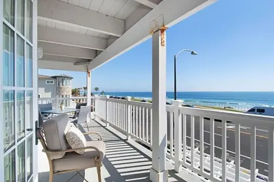 a balcony with chairs and a view of the ocean at Expansive Ocean View, Private Balcony, Across from Beach in Carlsbad
