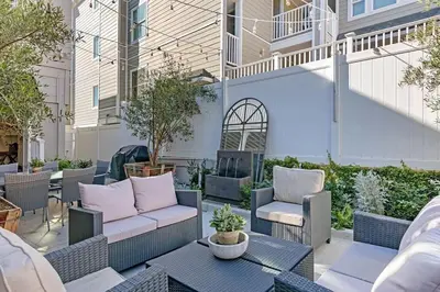 a patio with chairs and a couch and a table at Expansive Ocean View, Private Balcony, Across from Beach in Carlsbad