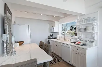 a kitchen with white cabinets and a white refrigerator at Expansive Ocean View, Private Balcony, Across from Beach in Carlsbad