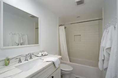 a bathroom with a sink and a toilet and a mirror at Expansive Ocean View, Private Balcony, Across from Beach in Carlsbad