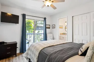 a bedroom with a bed and a ceiling fan at Walk on the Ocean! Wake up to Beautiful Bay Views in Newport Beach