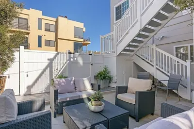 a patio with wicker chairs and a table at Ocean View From Private Patio, Across Street From Beach in Carlsbad