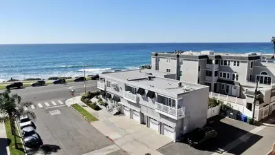 an aerial view of a building next to the ocean at Ocean View From Private Patio, Across Street From Beach in Carlsbad