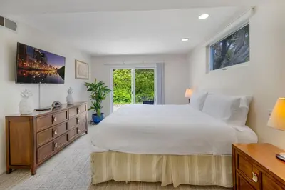 a bedroom with a large white bed and a window at Tattenham 1705 in Encinitas