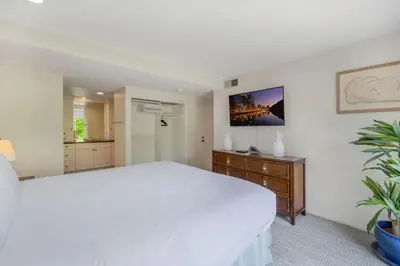 a white bedroom with a large bed and a dresser at Tattenham 1705 in Encinitas