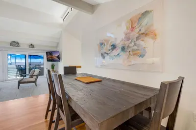 a dining room with a wooden table and chairs at Tattenham 1705 in Encinitas