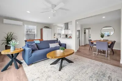 a living room with a blue couch and a table at Tower 9 #1 in Oceanside