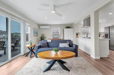 a living room with a blue couch and a table at Tower 9 #1 in Oceanside