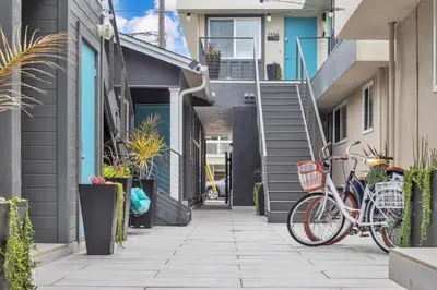 a bike parked on a sidewalk next to a building at Tower 9 #2 in Oceanside