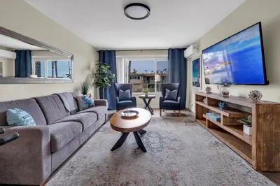 a living room with a couch and a large screen tv at Tower 9 #4 in Oceanside